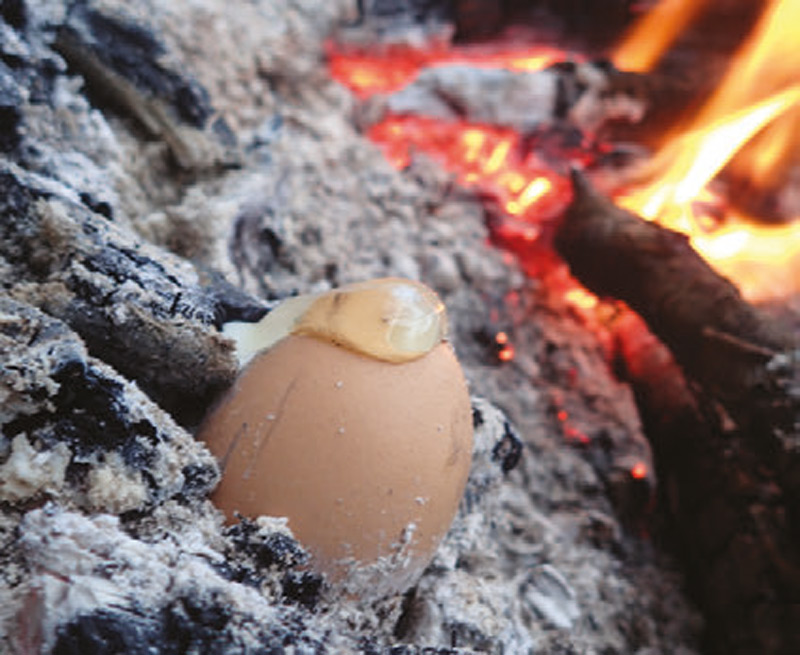 Eggs-must-have-a-small-hole-in-order-to-cook-correctly-in-the-coals-of-a-fire