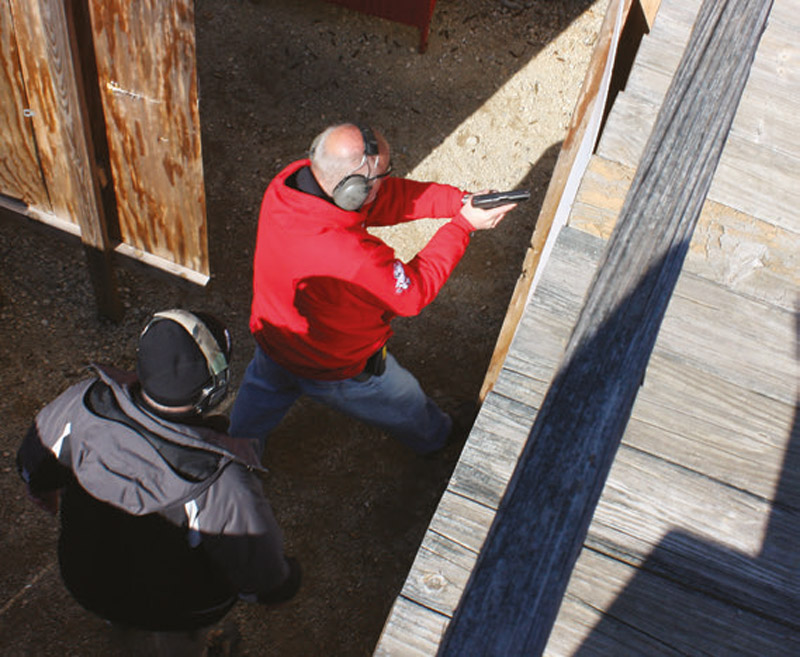 Followed-by-an-instructor,-student-prepares-to-navigate-live-fire-house