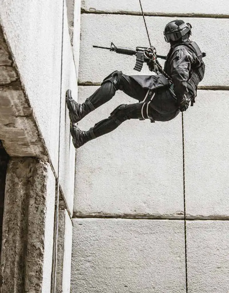 Canadian military members rappel from the roof of the Rogers