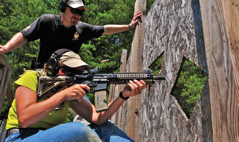 Instructor-Clay-Smith-looks-on-while-author-works-her-way-across-The-Wall