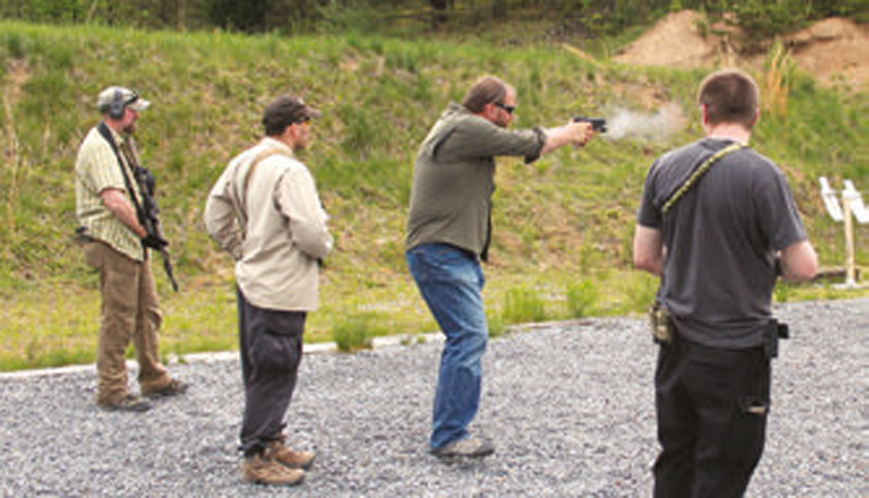 Matt-Graham-demonstrates-conga-line-drill,-weaving-among-students-and-engaging-threats-while-maintaining-muzzle-discipline