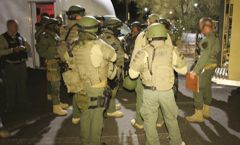 Members-of-Regional-SWAT-team-brief-prior-to-deploying-on-several-cartel-stash-houses