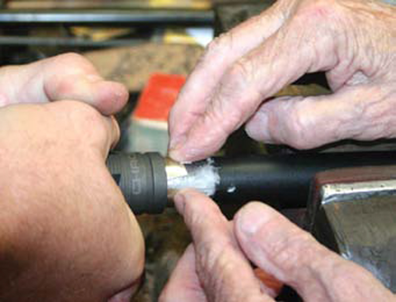 Seasoned-hands-attach-muzzle-brake-with-silver-solder-tape