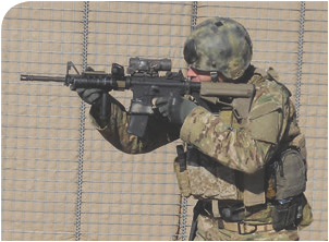 As seen from shooter’s left side, thumb and index finger form a C. He is letting the last three fingers of his hand fall naturally against the vertical grip, facilitating a straight pull-back on the rifle into his shoulder. Author prefers a vertical grip to a slick rail because the vertical grip enhances the C-clamp for him. With a slick rail, he tends to pull off to his support-hand side when a lot of tension is applied.