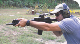 This shooter prefers to run support arm as far out as he can. Same principle of the hand forming a C against the side of the rail applies, but this shooter feels more natural with a straight arm. The straight pull-back of the rifle into the shoulder facilitates driving the rifle onto target.