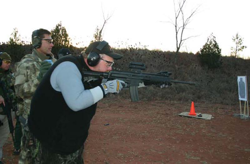 Falla-with-timer-in-hand-as-student-shoots-timed-drill