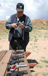 Farnam-inspects-students’-handguns-prior-to-Battlefield-Pick-Up-drill