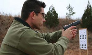 Jason-Falla-demonstrates-high-ready-position-with-handgun