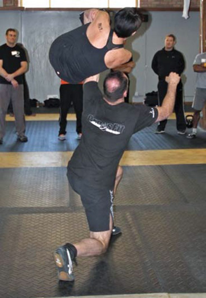 Jeff-Martone-performs-Turkish-Get-Up-with-135-pound-student