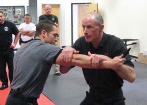 Lead-instructor-Doug-Tangen-demonstrates-moving-offline-and-inward-to-stop-the-attack