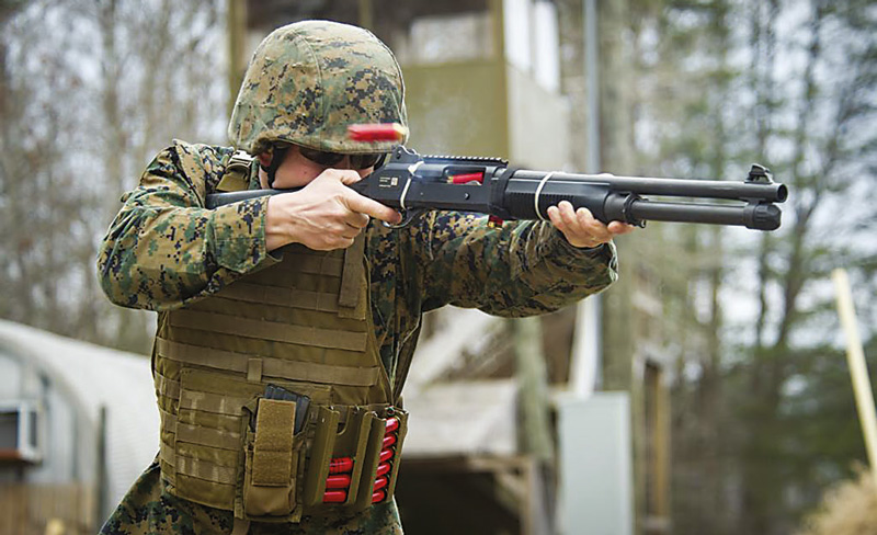 U.S.-Marine-wearing-two-Tactical-Stripper-units-while-firing-M1014-shotgun
